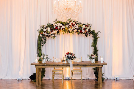 burgundy floral ceremony arch